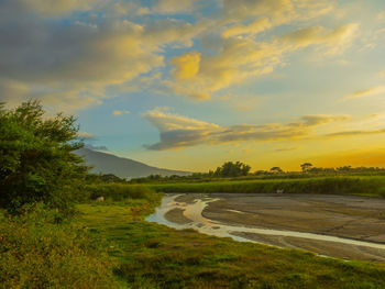 Scenic view of lake against sky during sunset