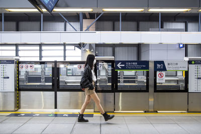 Side view of man walking in city