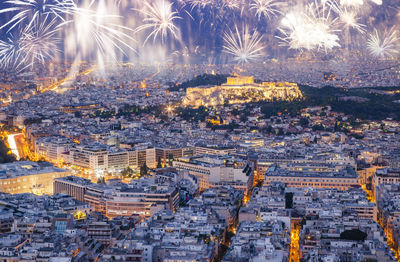 High angle view of illuminated buildings in city at night