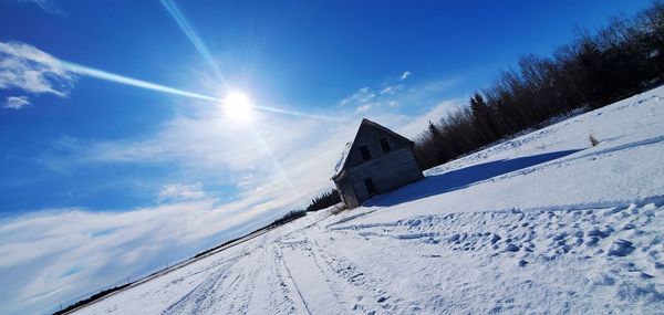 Low angle view of snow covered landscape against sky