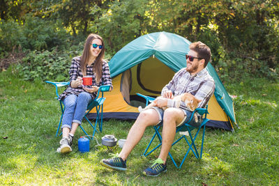 Young couple sitting in tent