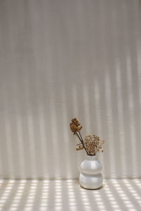 Close-up of white flower vase on table at home