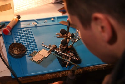 Cropped hand of man working on table