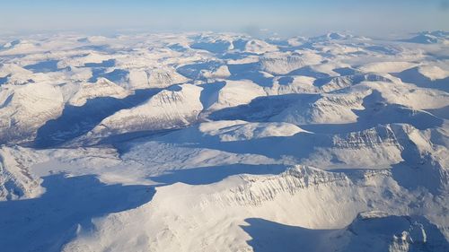 Aerial view of snowcapped mountains against sky