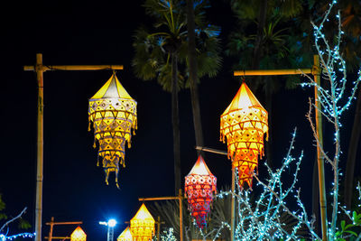 Low angle view of illuminated lanterns hanging by building