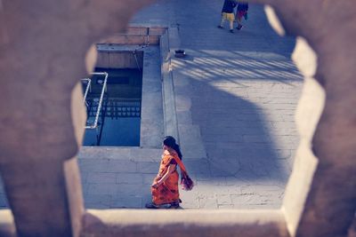 Rear view of women walking on building