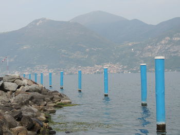 Scenic view of sea and mountains against sky