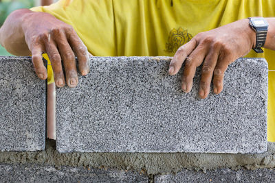 Midsection of bricklayer working at construction site