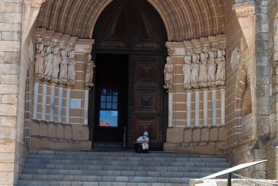 People at entrance of historic building