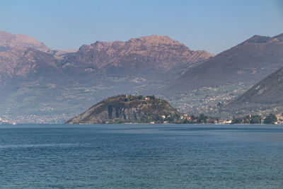 Scenic view of sea and mountain against sky