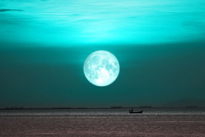 View of sea against moon at night