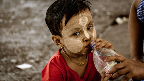 Portrait of man drinking water from glass