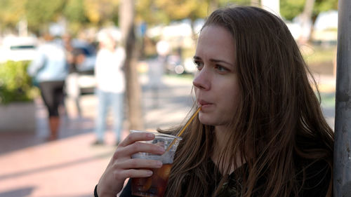 Close-up of young woman using mobile phone