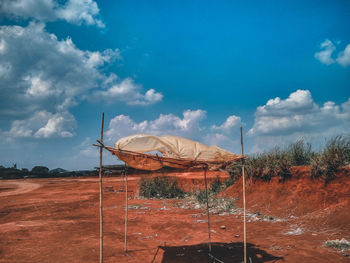 Traditional windmill on field against sky