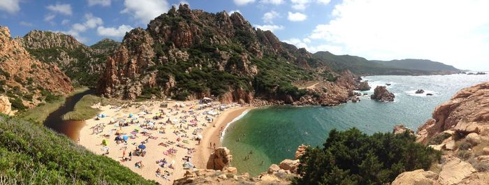 Scenic view of sea and mountains against sky