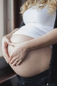 Midsection of woman standing at home