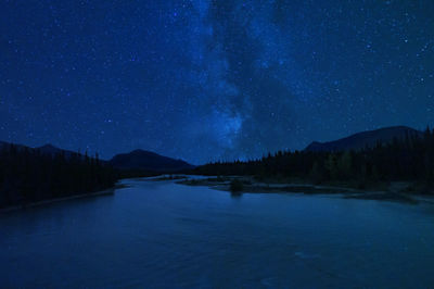 Scenic view of lake against sky at night