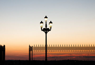 Street light against clear sky at sunset