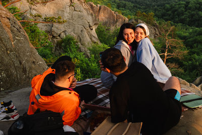 High angle view of woman sitting on rock