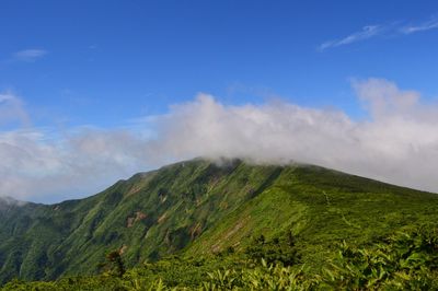 Scenic view of mountains against cloudy sky