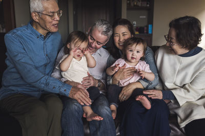 Portrait of multigenerational family laughing on couch