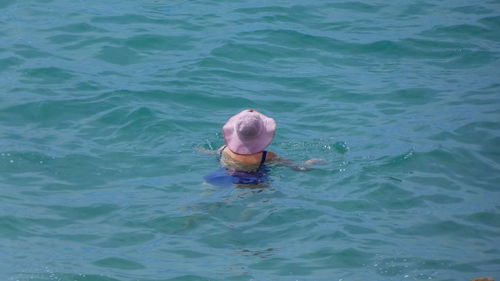 High angle view of woman swimming in sea