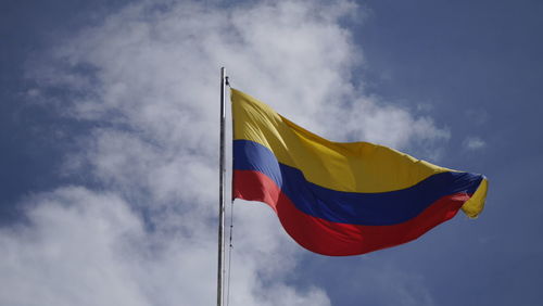 Low angle view of colombian flag against sky