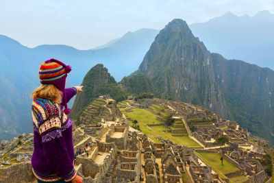 Rear view of woman looking at mountains