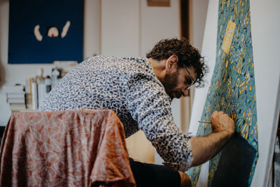 Side view of young man looking at home