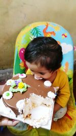 High angle view of boy with multi colored candies