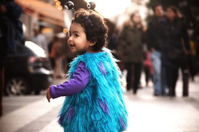 Smiling cute girl wearing costume while standing outdoors