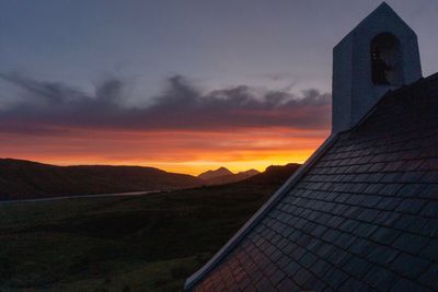 Low angle view of building against sky during sunset