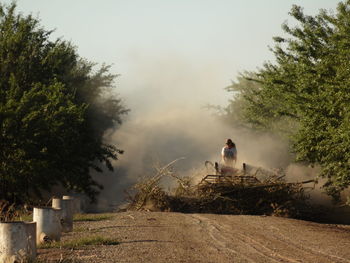 Man driving agricultural machinery at farm