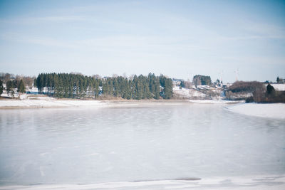 Scenic view of frozen lake against sky during winter