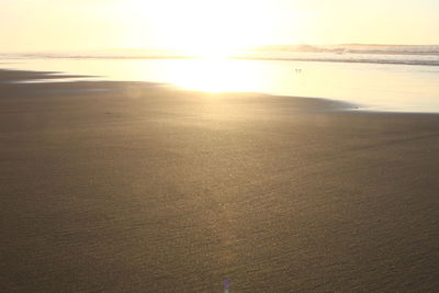 Scenic view of beach against sky during sunset