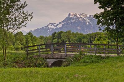 Scenic view of field and mountains against sky