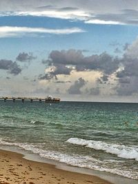 Scenic view of sea against cloudy sky