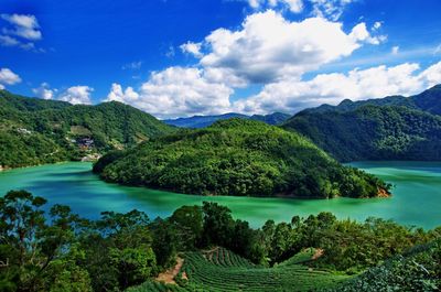 Scenic view of lake and mountains against sky