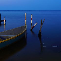 Boat moored in sea against sky