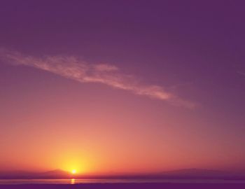 Scenic view of sea against romantic sky at sunset