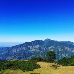 Scenic view of mountains against clear blue sky