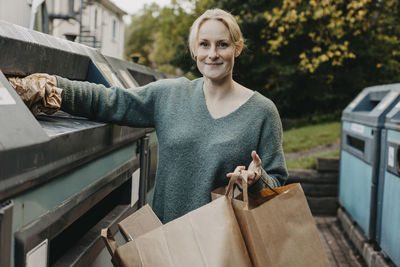 Woman recycling rubbish