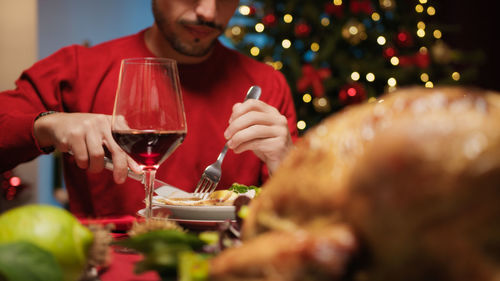 Close-up of woman having food at home