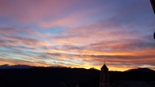 Silhouette buildings against sky during sunset