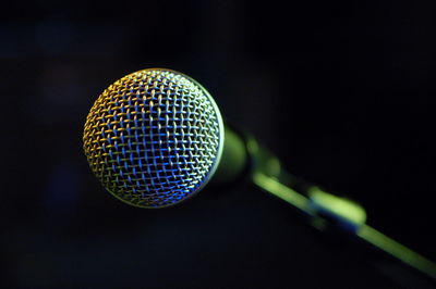 Close-up of electric fan against black background