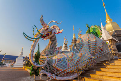 Low angle view of statue against blue sky