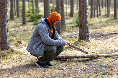 Rear view of woman standing in forest