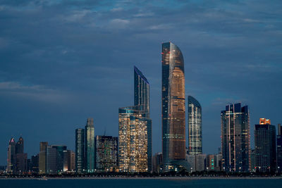 View of skyscrapers against cloudy sky