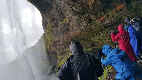 Photographers behind seljalandsfoss waterfall, iceland