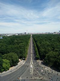 High angle view of street amidst trees against sky